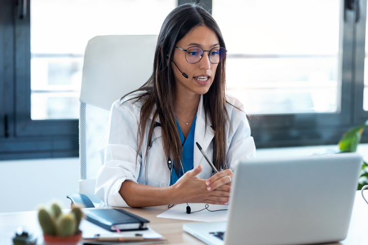 Physician connecting with a patient via telehealth.