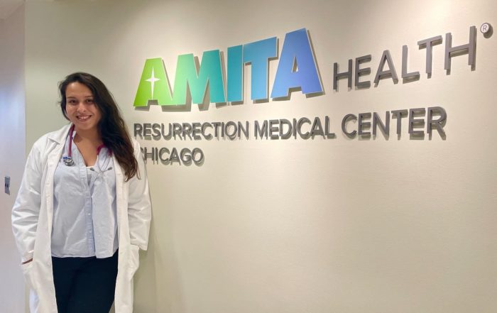AMO Visitor Stands in front of her clinic during her chicago away rotation
