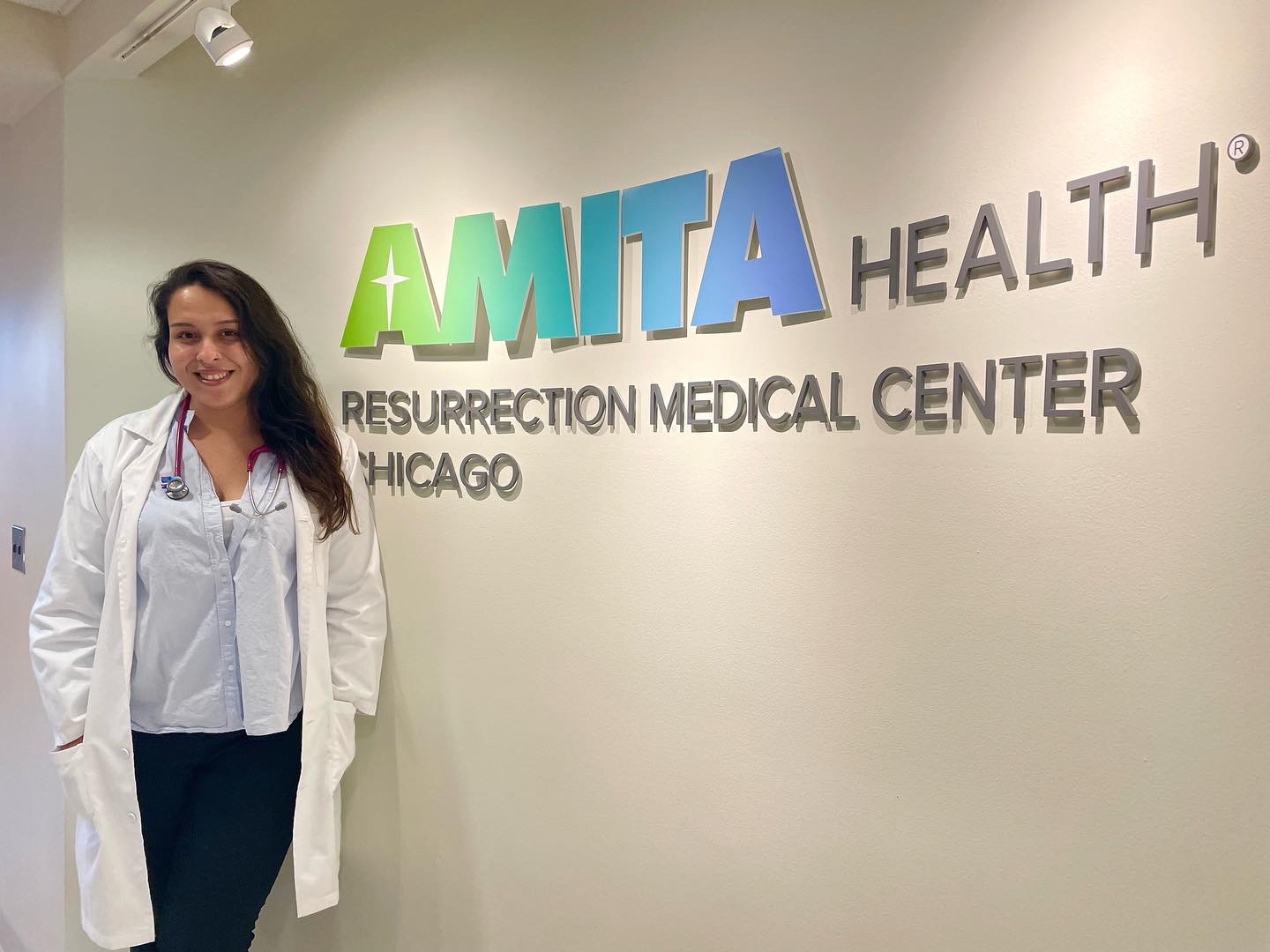 AMO Visitor Stands in front of her clinic during her chicago away rotation