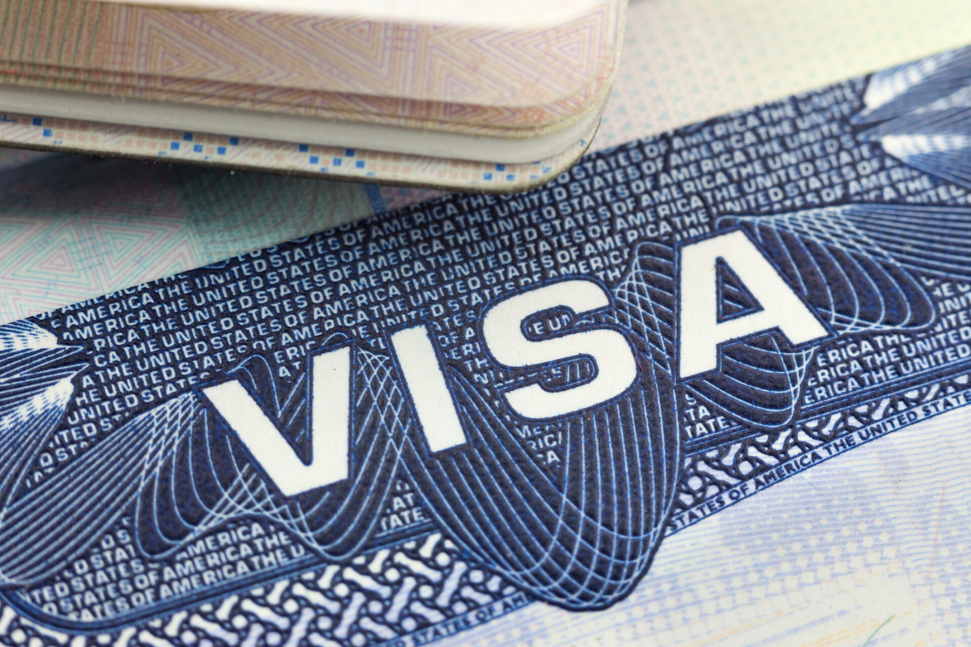 A close up of a visa sitting in a U.S. passport
